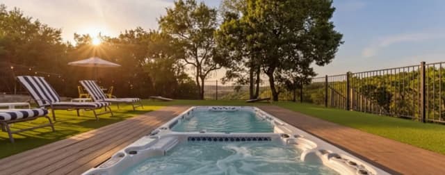 Hill Country stone home with oak trees and a wide front porch at golden hour